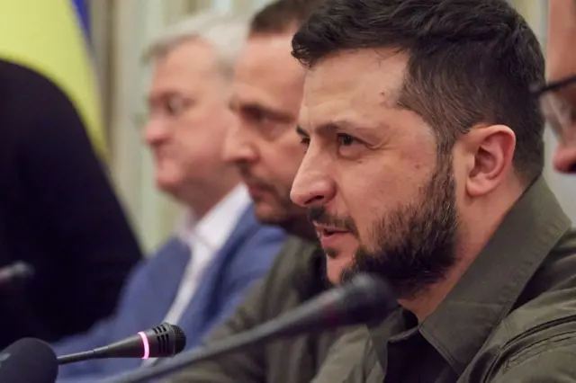 President Zelensky speaking into a microphone last month