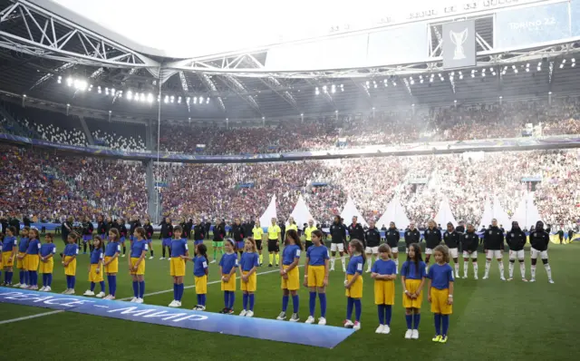 Teams lining up on pitch