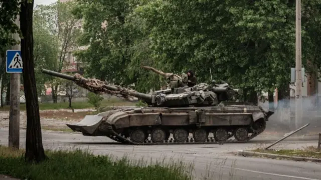 A Ukrainian tank drives through Severodonetsk