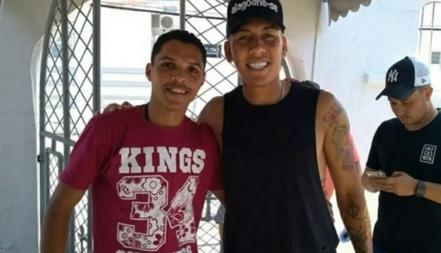 Firmino poses with former classmate and Flamenguinho team-mate Lucialdo da Silva Almeida during a visit to Trapiche in 2018 when he donated 500 food baskets, snacks and toys for the schoolchildren