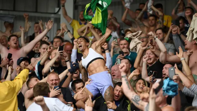 Raphinha celebrates with Leeds fans