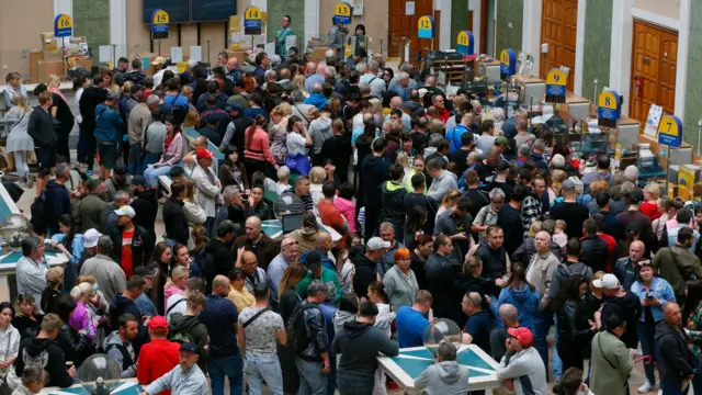 People queue at a post office in Odesa, Ukraine