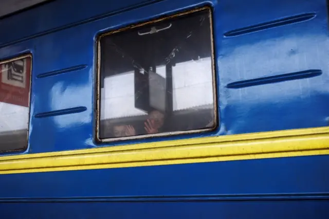 A woman and a boy wave to relatives as an evacuation train to Lviv prepares to depart Kharkiv, eastern Ukraine. File photo