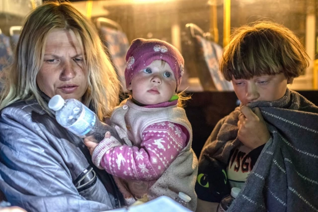 A mother and her two children arrive at a centre for displaced in Ukraine's city of Zaporizhzhya after fleeing their home town of Mariupol. File photo