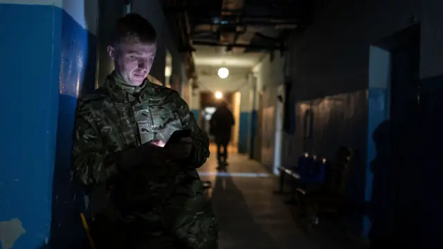 A paramedic waits inside a shelter near a hospital in Bakhmut in the Donetsk region