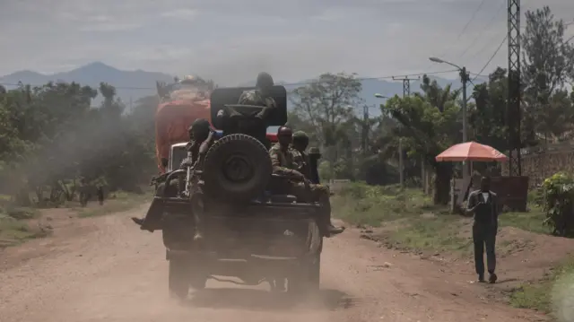 Soldiers drive through the streets of Rutshuru in their cars days after clashes with the M23 rebels in Rutshuru