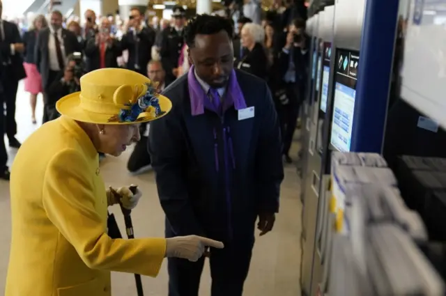 The Queen looking a Crossrail ticket machine