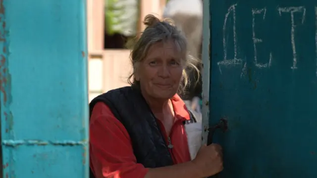 Liudmyla standing in front of door