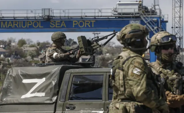 A picture taken during a visit to Mariupol organized by the Russian military shows Russian servicemen guard the territory of the cargo sea port in Mariupol, Ukraine, 29 April 2022