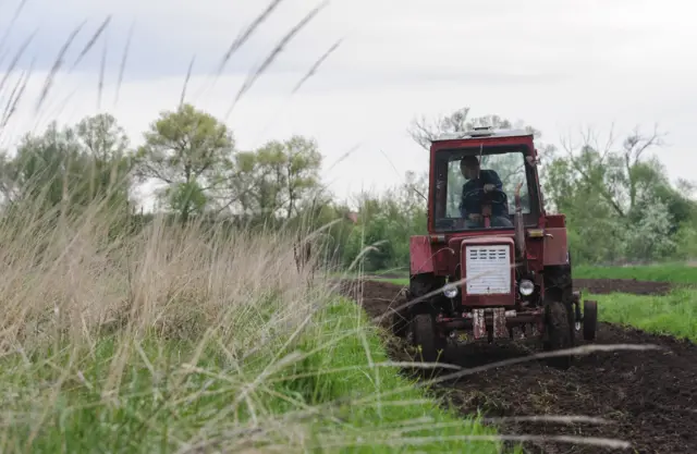 A farmer works on a field near Lviv