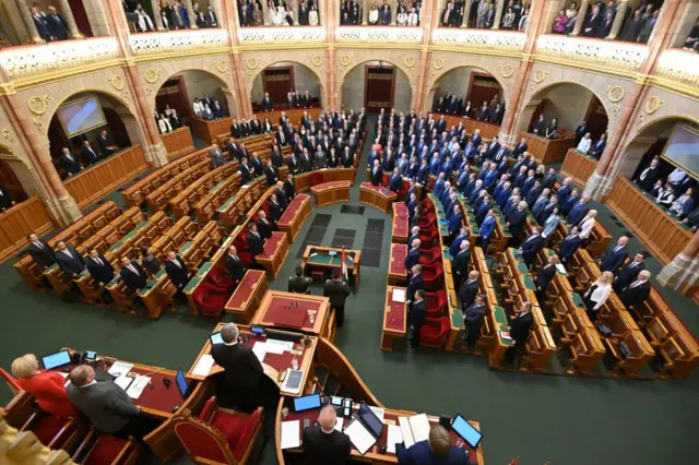 A wide shot of Hungarian MPs taking an oath in parliament