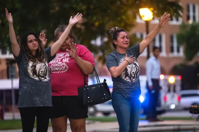 People hold a vigil in the town