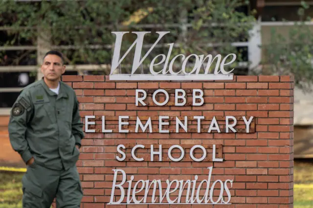 A law enforcement officer stands guard outside the school on Wednesday morning