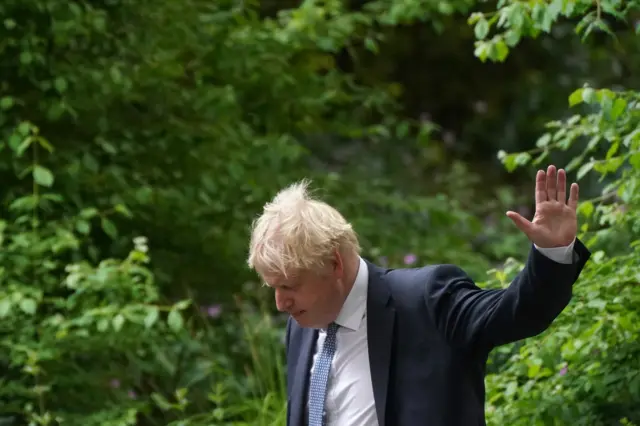 Boris Johnson walks down Downing Street in London after the press conference