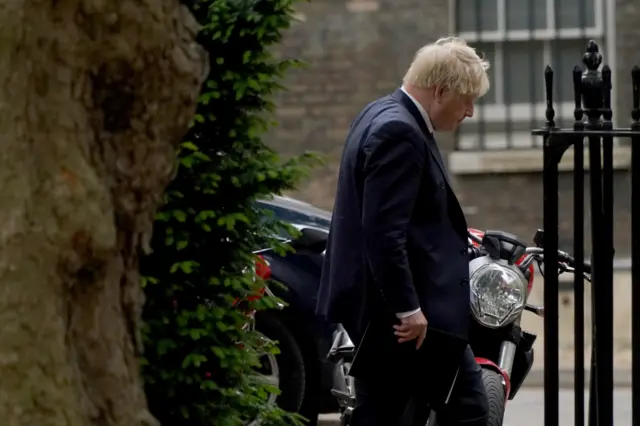 Boris Johnson heads to a press conference in Downing Street