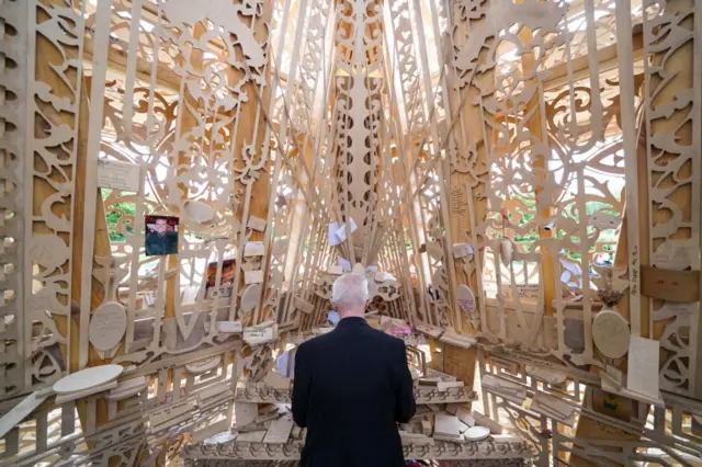 Archbishop of Canterbury Justin Welby writes a message at Sanctuary, a national memorial to honour the UK's loss to Covid-19