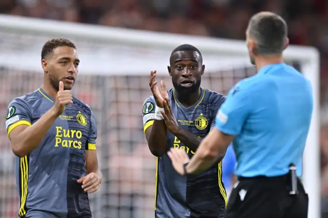 Cyriel Dessers and Lutsharel Geertruida of Feyenoord appeal for a penalty