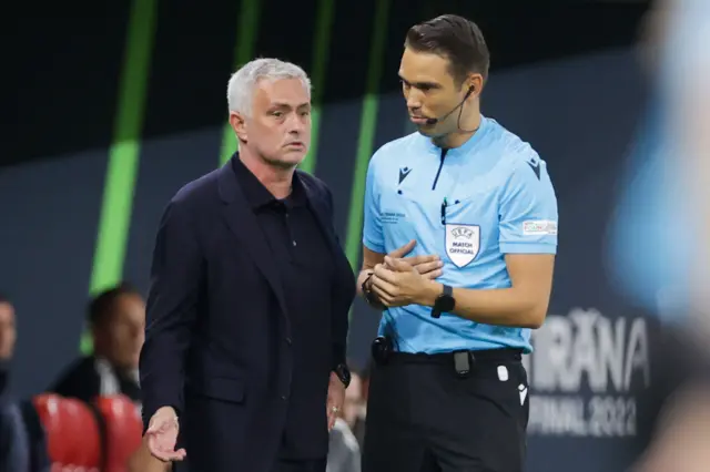 Roma's Portuguese head coach Jose Mourinho (L) speaks with Swiss fourth official Sandro Scharer during the UEFA Europa Conference League final