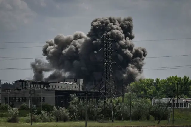 Smoke and dirt ascends after a strike at a factory in the city of Soledar at the eastern Ukranian region of Donbas on May 24, 2022,