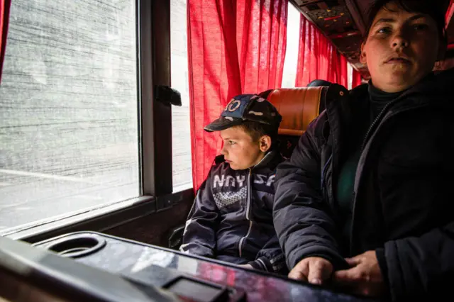 A child looks out after boarding an emergency evacuation bus from Bakhmut to Dnipro in south-east Ukraine