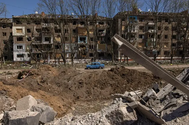 A crater and damaged buildings in Kramatorsk, eastern Ukraine