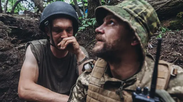 Ukrainian soldiers sheltering from shelling on the front line in the Donbas area