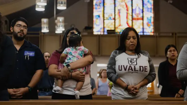 Mourners pray at a Catholic parish in Uvalde