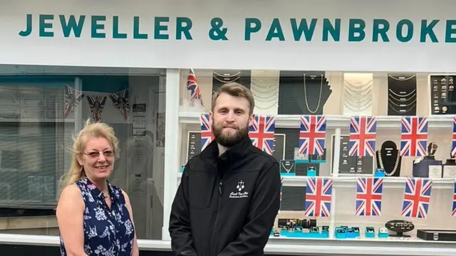 Pawnshop owner Connor Smith and manager Tracey pictured outside their premises