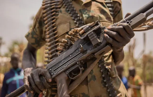 A rebel South Sudan soldier poses with his gun in Touch Riak, Leer county, on March 7, 2018