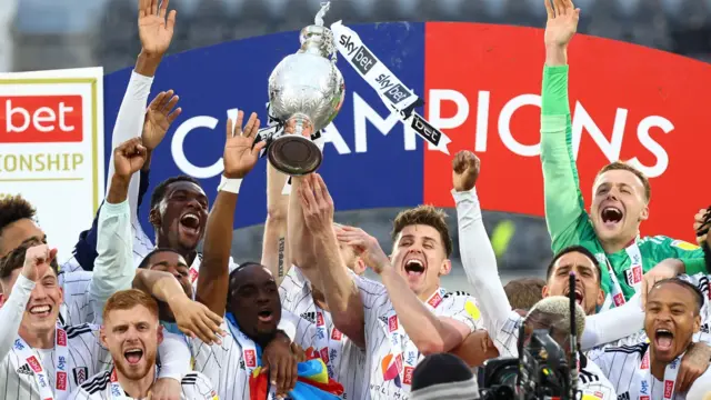 Fulham players celebrate with the Championship trophy