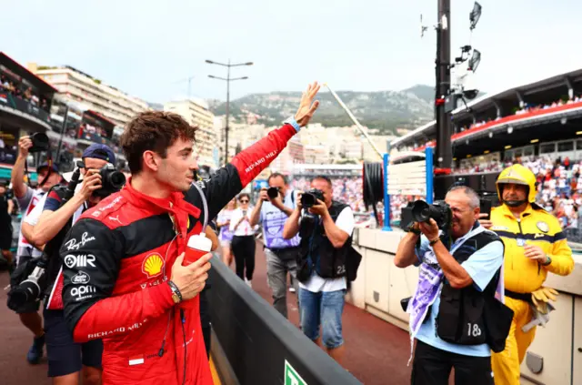 Charles Leclerc waves to fans