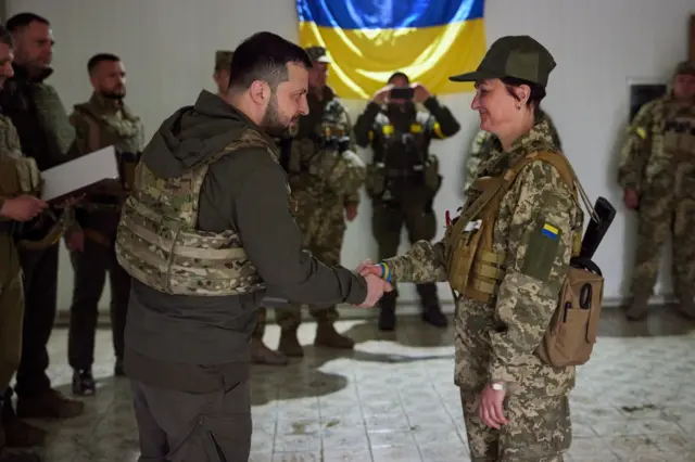 Volodymyr Zelensky and a servicewoman