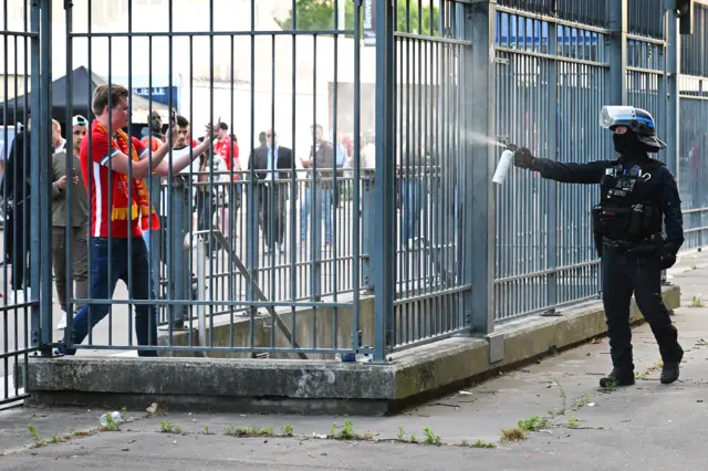 A Liverpool fan is pepper sprayed outside the Stade de France in Paris before the Champions League final