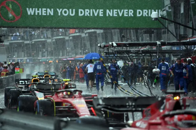 Drivers line up in pit lane