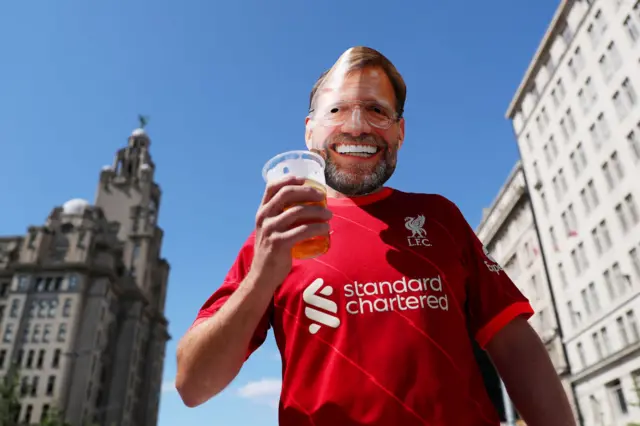 A fan in a Jurgen Klopp mask