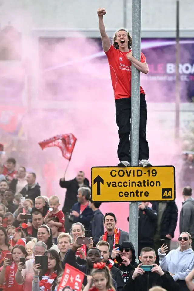 A Liverpool fan punches the air