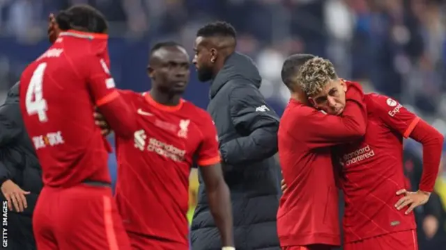 Liverpool players including Roberto Firmino look dejected after the Champions League final defeat to Real Madrid