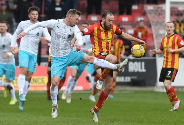 Billy Mckay and Stuart Bannigan battle for the ball