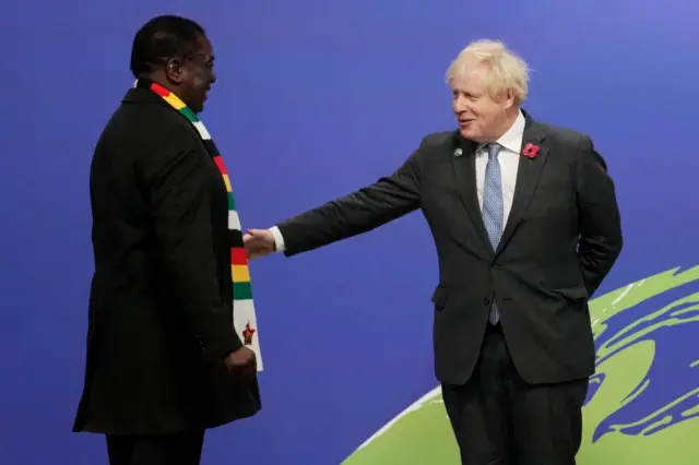 Britain's Prime Minister Boris Johnson greets Zimbabwe's President Emmerson Mnangagwa