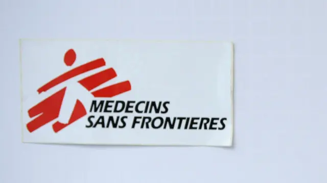 The Doctors Without Borders logo pinned to a wall.