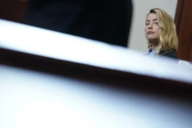 Actress Amber Heard stands in the courtroom at the Fairfax County Circuit Court during a defamation case against her by ex-husband, US actor Johnny Depp, in Fairfax, Virginia, on May 4, 2022