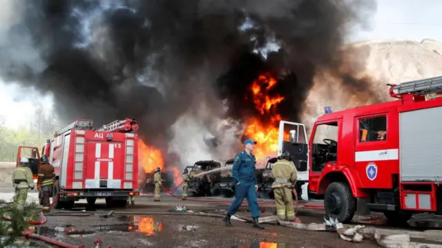 Firefighters extinguish fires at an oil depot on the outskirts of Donetsk