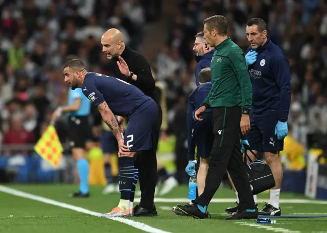 Pep Guardiola interacts with Kyle Walker