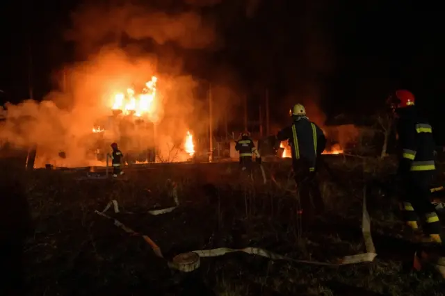 Firefighters work at a site of a power substation hit by a missile strike