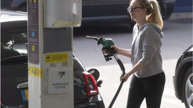 A woman at a petrol pump