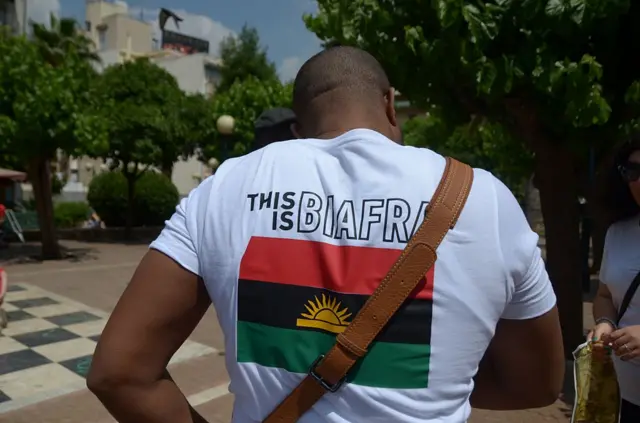 A demonstrator wears a t-shirt that reads "This is Biafra"