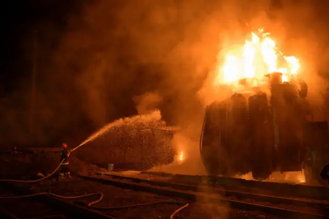 Firefighters trying to put out a blaze at one of the stations