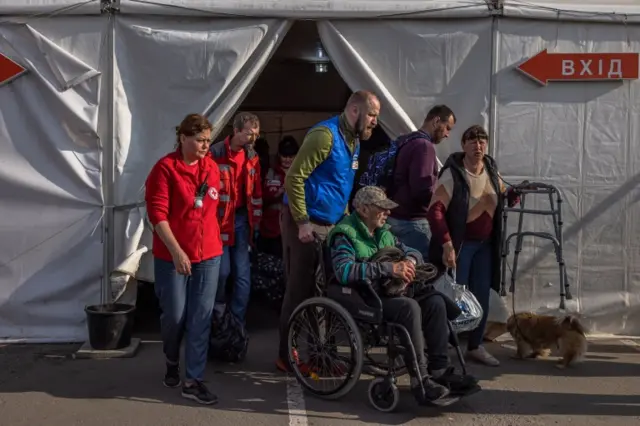 A man is pushed on a wheelchair, who was evacuated from Mariupol at the evacuation point, in Zaporizhzhia, Ukraine, 3 May