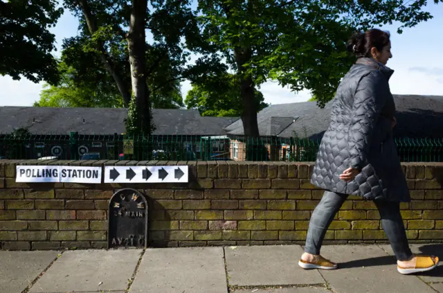 Woman on her way to vote in Wakefield, West Yorkshire