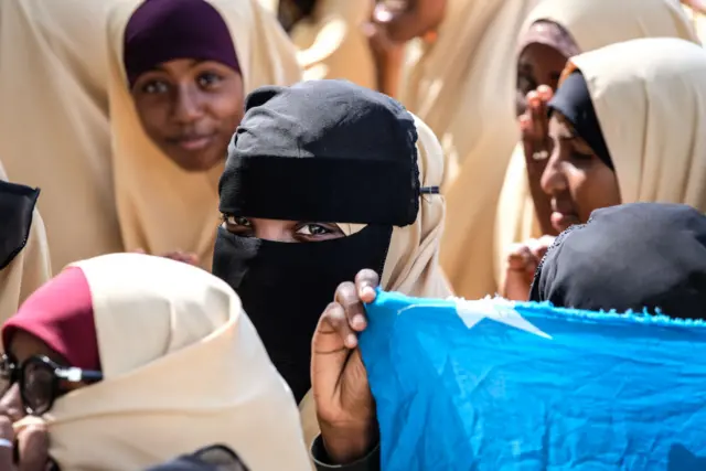 School children hold the Somali national flag.
